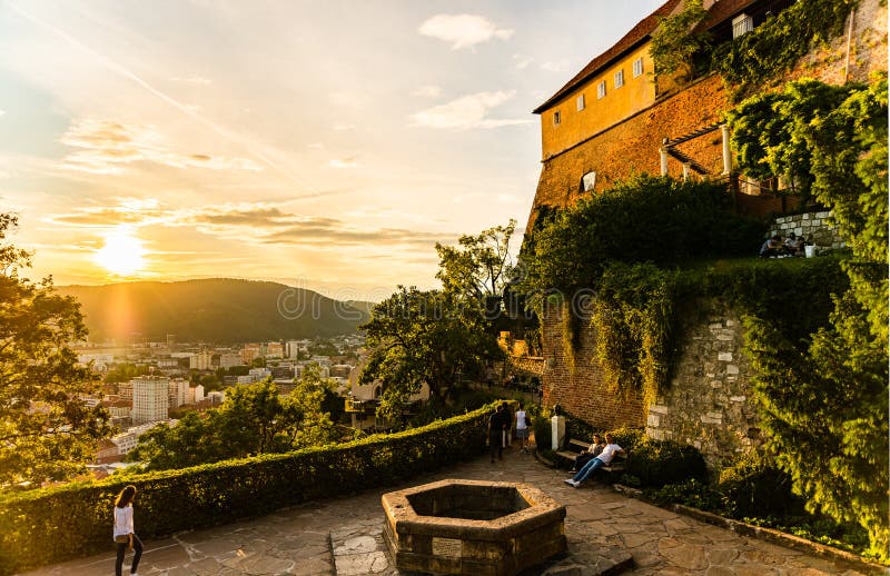 View at famous Castle at Schlossberg hill and wish well. Above Graz city during sunset in summer royalty free stock photos View at famous Castle at Schlossberg hill and wish well. Above Graz city during sunset in summer royalty free stock photos