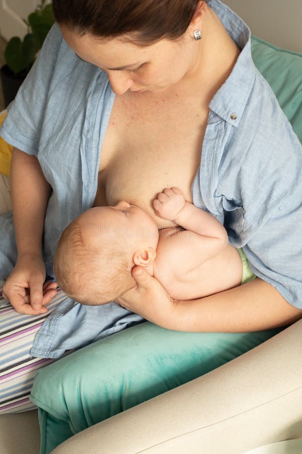 4 Football Breastfeeding Position - Mother Holding Her Sweet Newborn Baby  While Feeding it with her Nourishing Nipple in Football Position Stock  Illustration | Adobe Stock