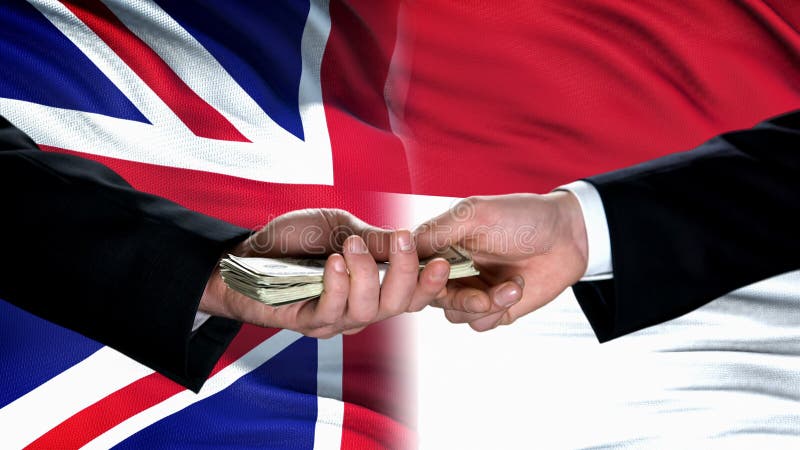 Great Britain and Indonesia officials exchanging money, flag background, deal royalty free stock images Great Britain and Indonesia officials exchanging money, flag background, deal royalty free stock images