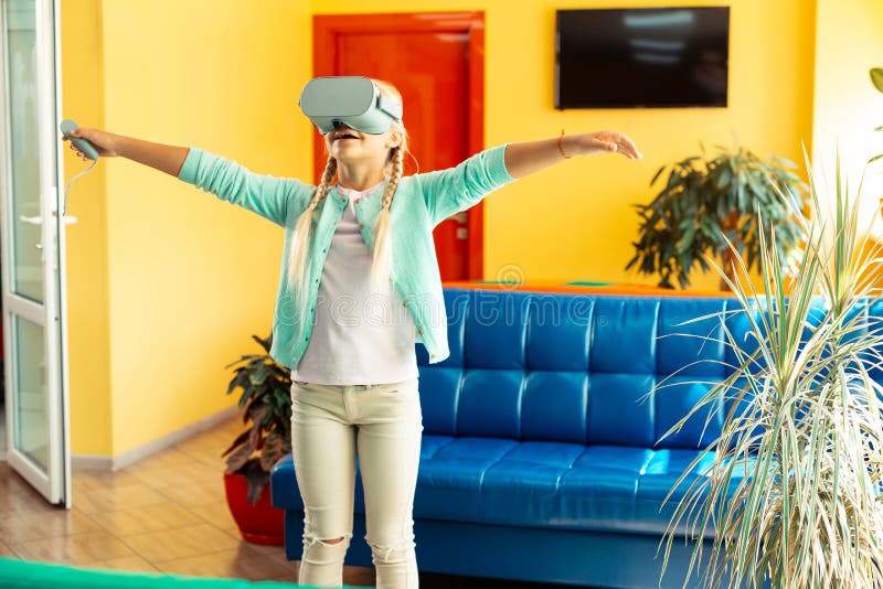 Girl imagining herself flying during school breaktime. royalty free stock photography