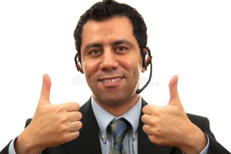 Handsome Male Customer Service answering the phone while giving two thump up with his hand The photo was shot in studio lights. Handsome Male Customer Service answering the phone while giving two thump up with his hand The photo was shot in studio lights