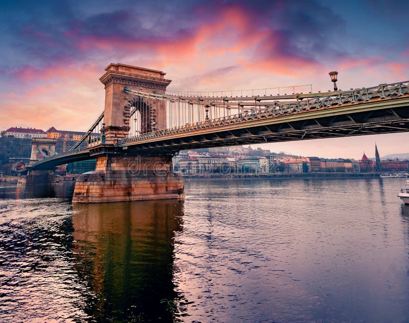 Great spring cityscape of Budapest town, capital of Hungary, Europe. Picturesque sunrise on Danube river with Chain Bridge. Traveling concept background