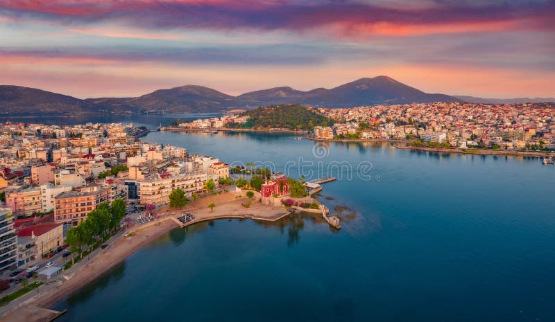 Great sunrise in Chalcis town. Stunning morning seascape of Aegean sea, North Euboean Gulf. Impressive summer scene of Euboea island, Greece, Europe. Traveling concept background