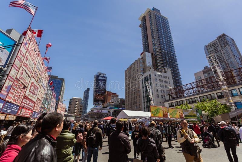 Toronto, Ontario, Canada, down town, May 20, 2017, great inviting view of down town Toronto dundas square on young street with various modern buildings and people walking in background. Toronto, Ontario, Canada, down town, May 20, 2017, great inviting view of down town Toronto dundas square on young street with various modern buildings and people walking in background