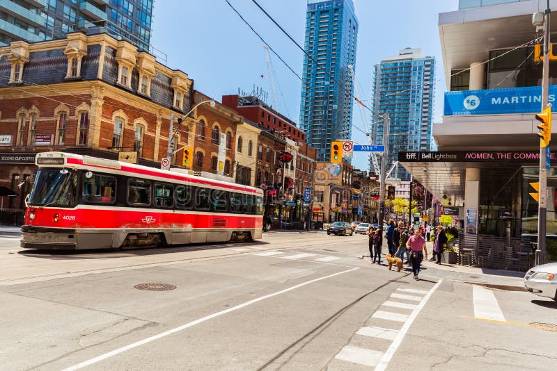 Great view of old street car with fragment of old and modern buildings, walking people in background royalty free stock photo