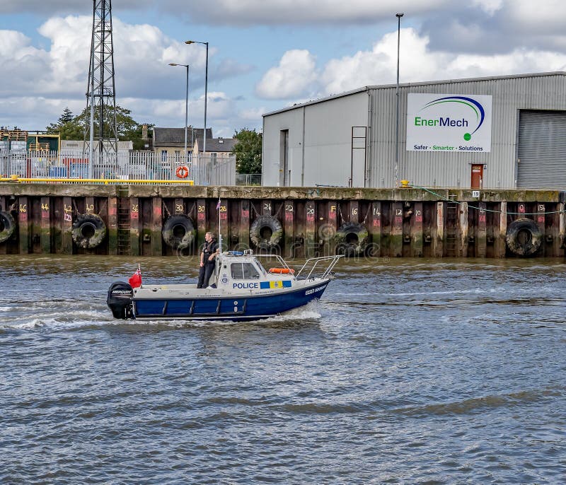 Great Yarmouth, Norfolk, UK – September 08 2019. The Police boat sailing down the River Yare with a single police office on board in the town of Great Yarmouth. Great Yarmouth, Norfolk, UK – September 08 2019. The Police boat sailing down the River Yare with a single police office on board in the town of Great Yarmouth