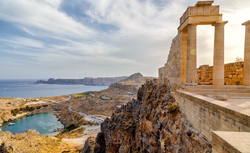 Greece. Rhodes. Acropolis of Lindos. Doric columns of the ancient Temple of Athena Lindia the IV century BC and the bay of St. Paul. Greece. Rhodes. Acropolis of Lindos. Doric columns of the ancient Temple of Athena Lindia the IV century BC and the bay of St. Paul