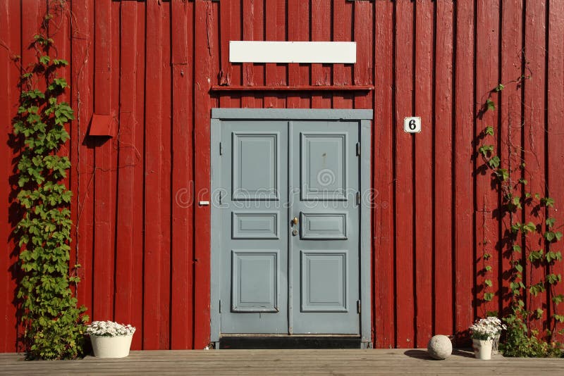 Grey door with red wooden wall