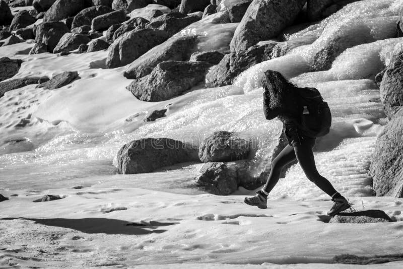Gredos, Spain. 12-January-2019. Monochrome picture of woman trekker walking through ice during a winter sunny day royalty free stock photos Gredos, Spain. 12-January-2019. Monochrome picture of woman trekker walking through ice during a winter sunny day royalty free stock photos