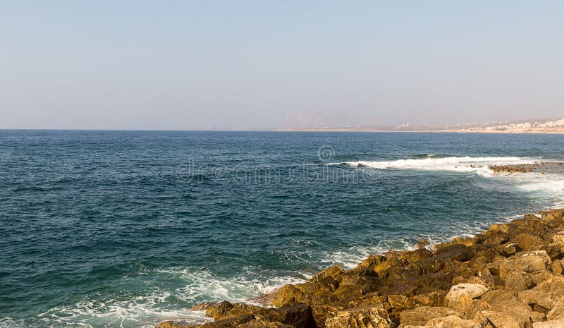 Greece Crete Island azure sea is broken on the stony shore on a clear sunny day royalty free stock photo Greece Crete Island azure sea is broken on the stony shore on a clear sunny day royalty free stock photo