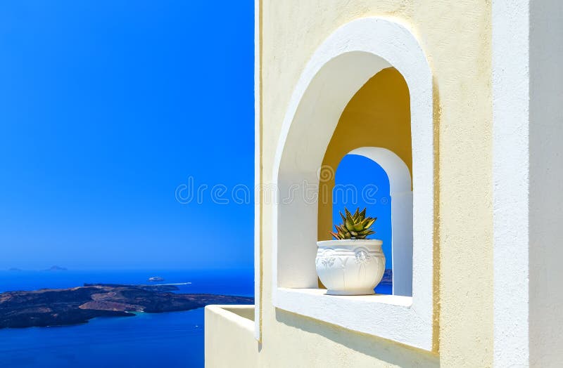 Greece Santorini island in Cyclades, traditional detail sights of colorful flowers with pots and caldera sea in background