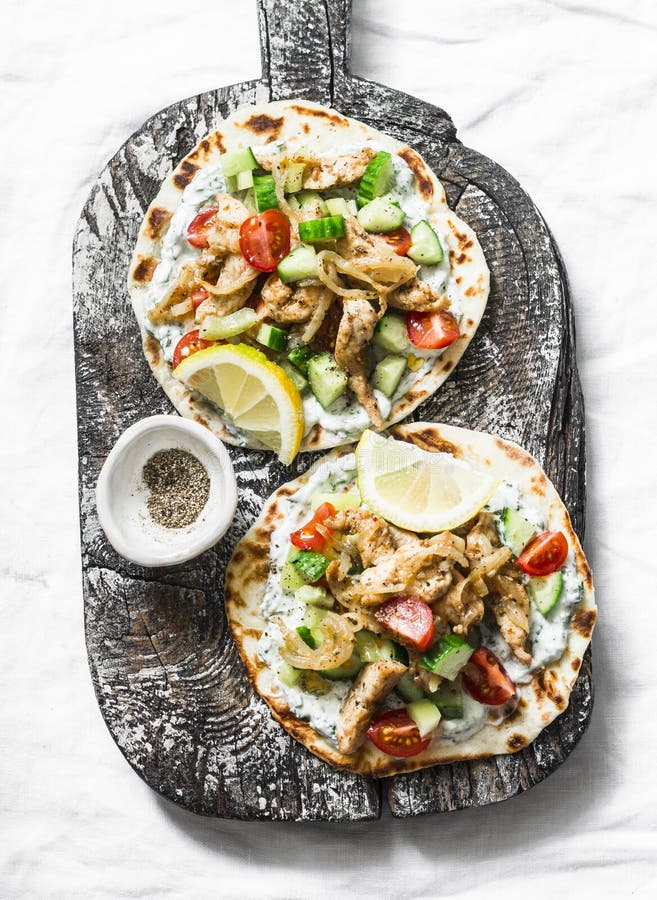 Greek Chicken Gyros Flatbread on a Rustic Cutting Board on a Dark ...