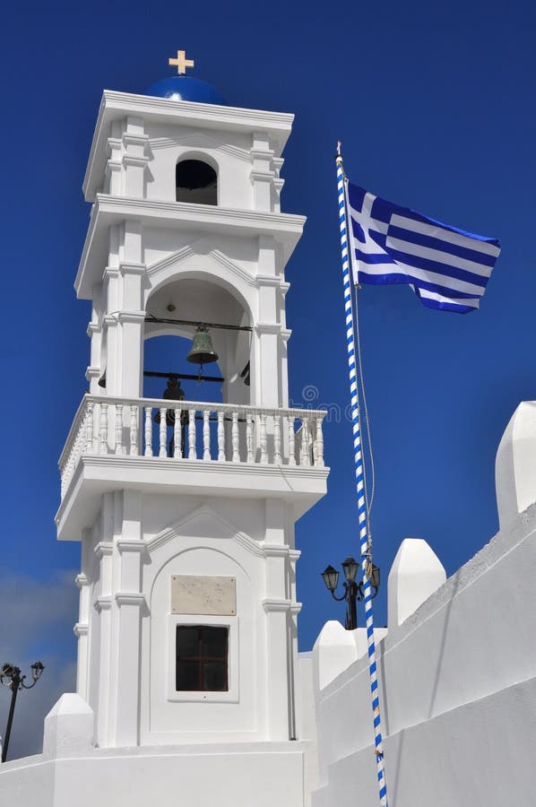 Greek flag next to church tower, santorin