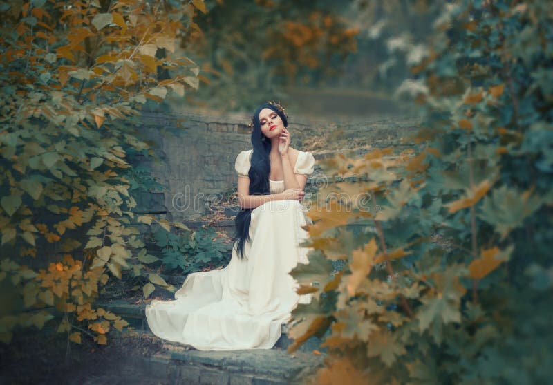 Greek goddess sits on the stone steps in autumn forest, light skin, white long elegant dress, like a sculpture, black royalty free stock photo Greek goddess sits on the stone steps in autumn forest, light skin, white long elegant dress, like a sculpture, black royalty free stock photo