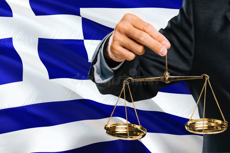 Greek Judge is holding golden scales of justice with Greece waving flag background. Equality theme and legal concept stock images Greek Judge is holding golden scales of justice with Greece waving flag background. Equality theme and legal concept stock images