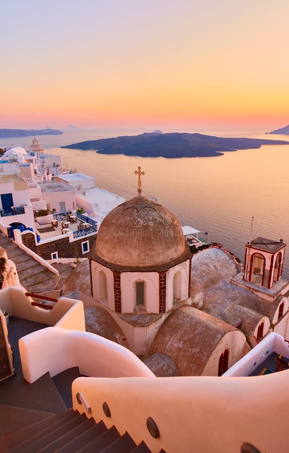 Fira town on the coast of Santorini island by the sea at dusk