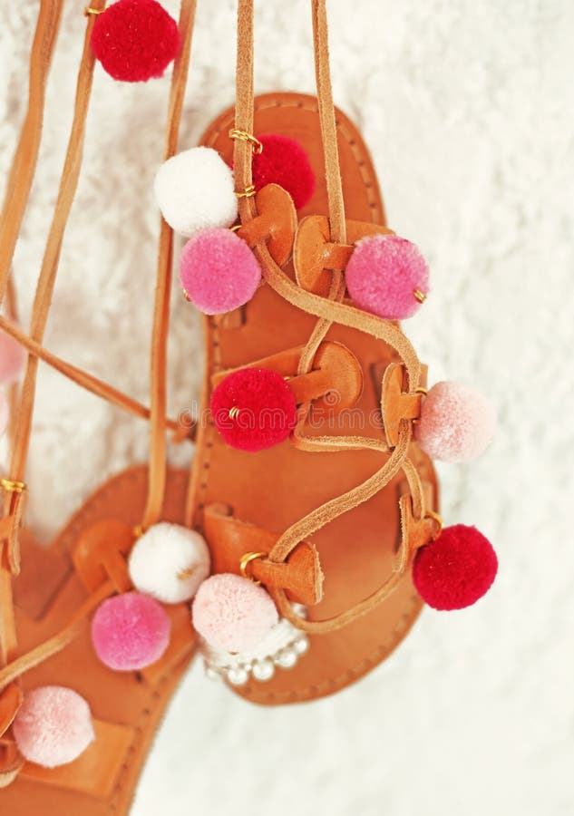 Greek leather sandals for girls with colorful pom pom - gladiator sandals stock photography Greek leather sandals for girls with colorful pom pom - gladiator sandals stock photography