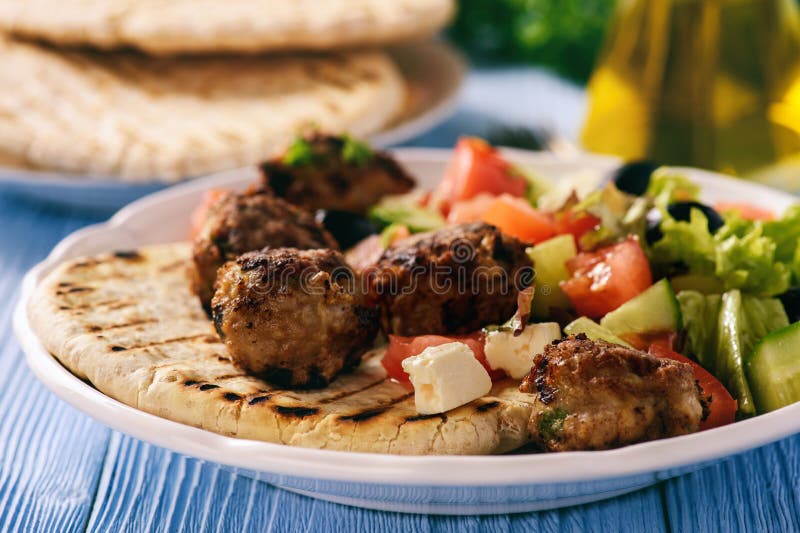 Greek meatballs keftedes with pita bread and tzatziki dip.