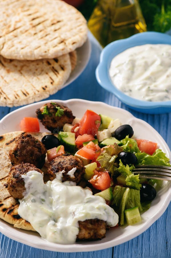 Greek meatballs keftedes with pita bread and tzatziki dip.