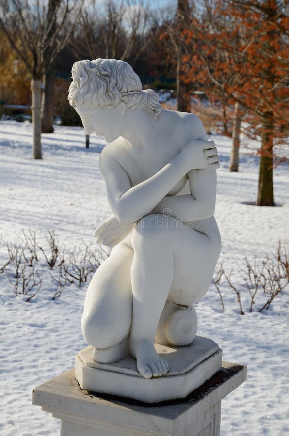 Marble nude statue in the cold season. 