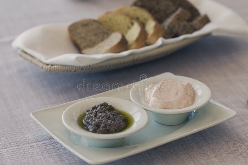 Greek Olive Paste and Tzatziki Sauce with Bread on the Table Stock