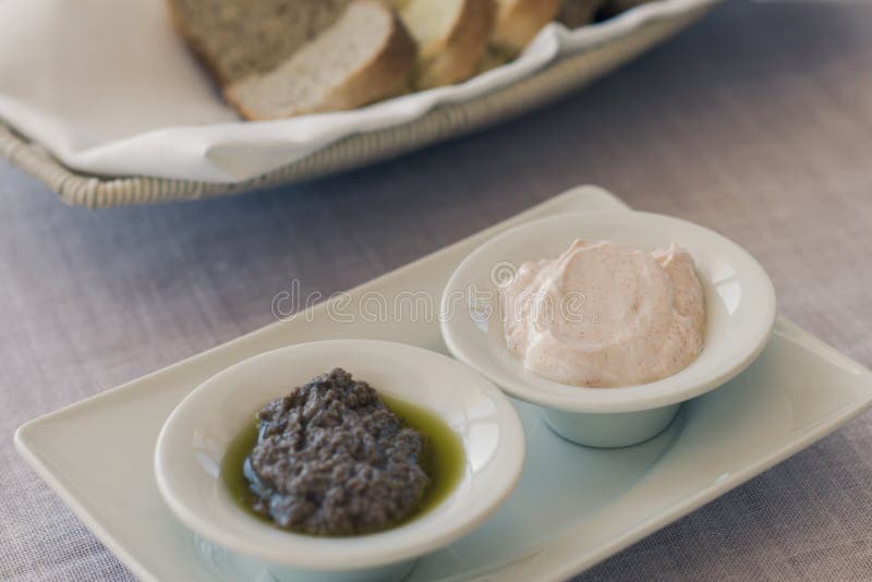Greek Olive Paste and Tzatziki Sauce with Bread on the Table Stock