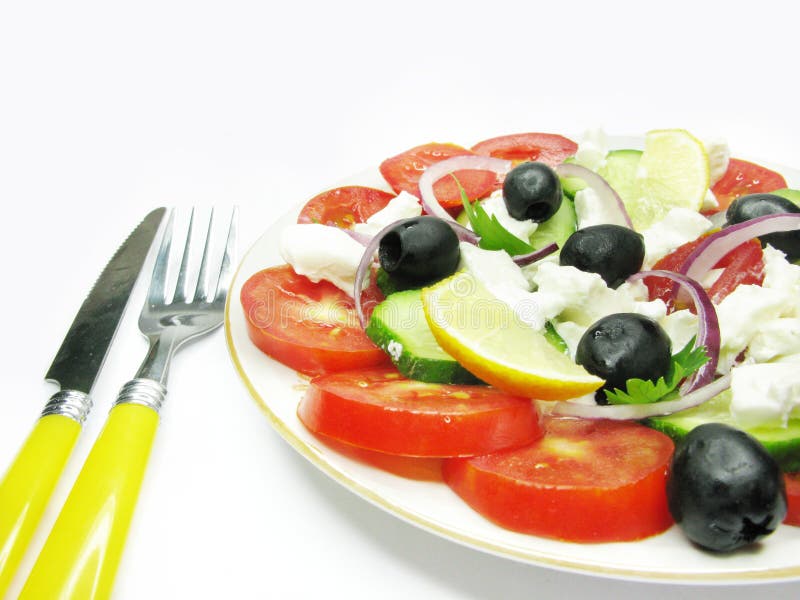Greek salad with fork and knife