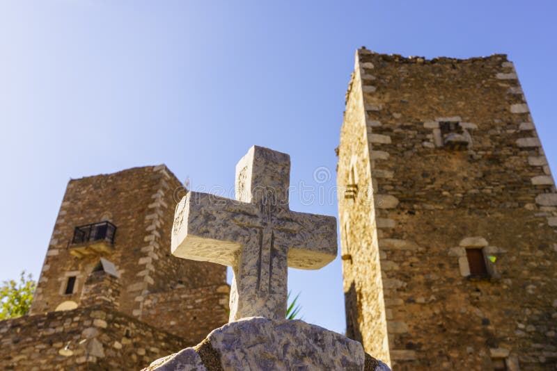 Greek stone cross and tower house, Greece