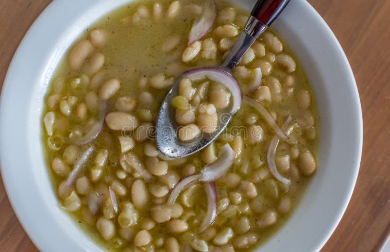 Greek traditional soup of beans in white sauce and onions. royalty free stock images Greek traditional soup of beans in white sauce and onions. royalty free stock images