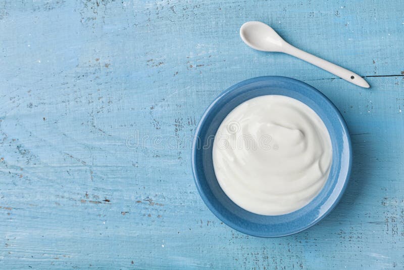 Image result for yogurt on blue wooden table