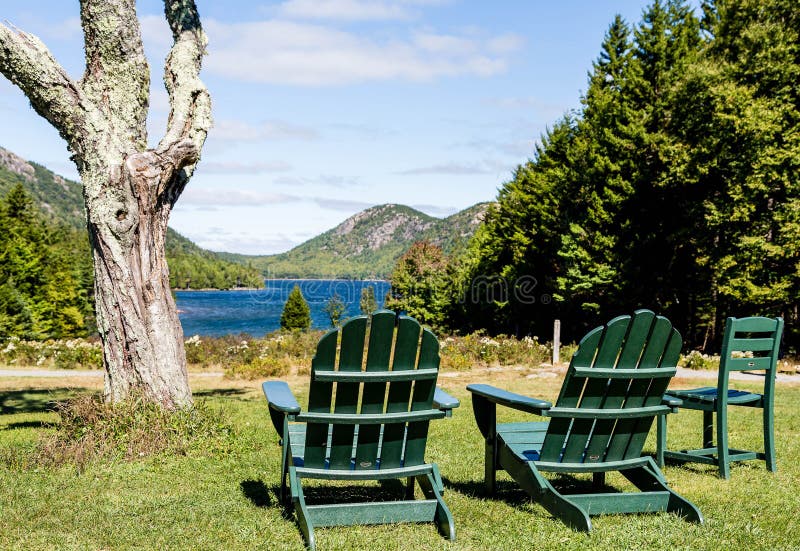 Green Adirondack Chairs Overlooking Lake