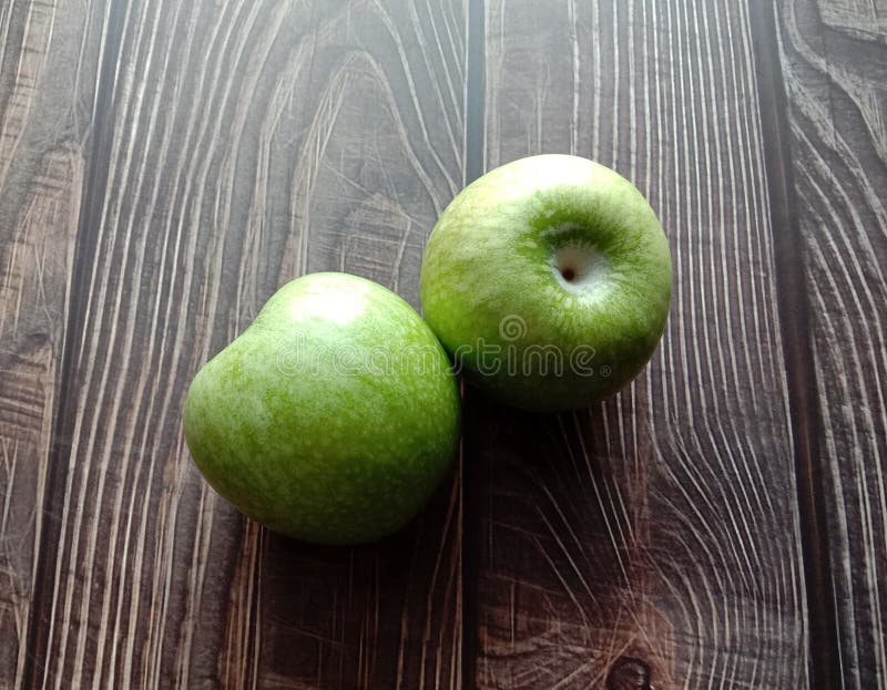 Green apple Malus domestica isolated on wallpaper background closeup.