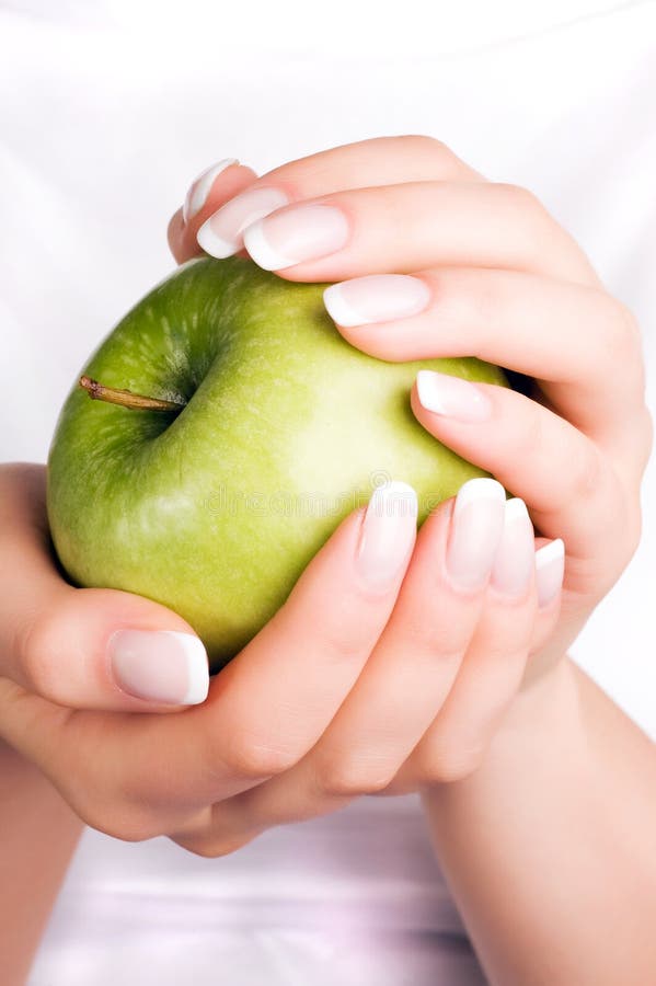 Green apple in woman s hands