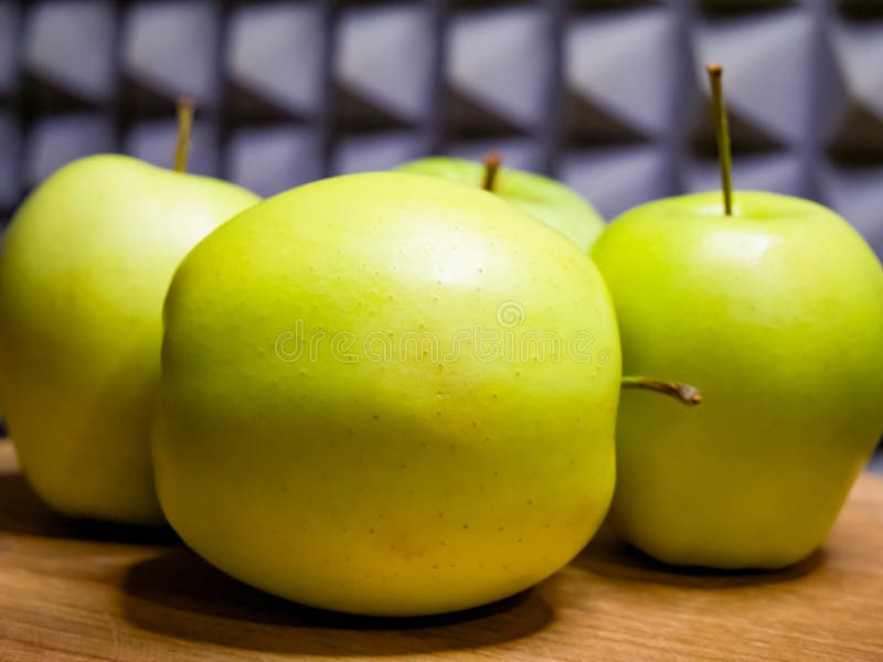 Green apples, wood, grey design, nutrition-related image stock photography