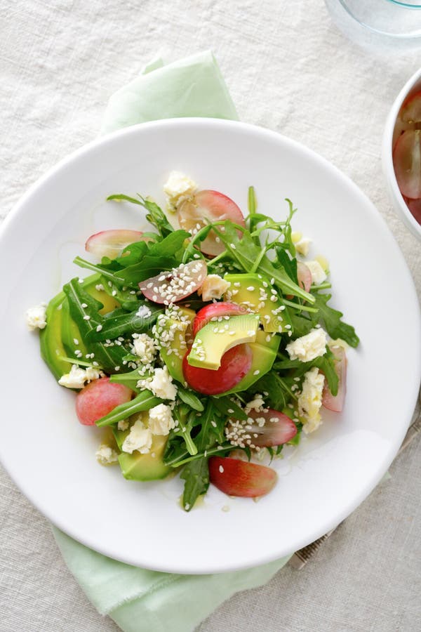Green Avocado Salad with Arugula, Grapes and Blue Cheese Stock Photo