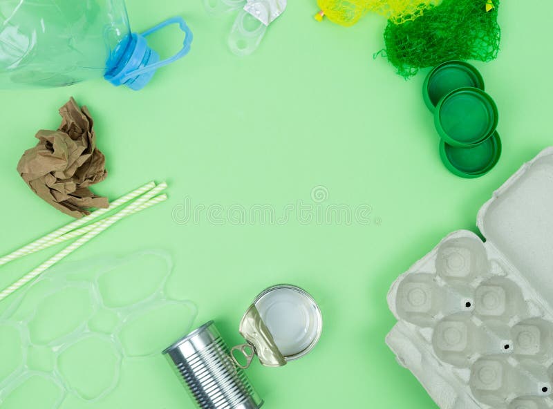 Green background with garbage objects for recycling and space in the center. Copy space royalty free stock image
