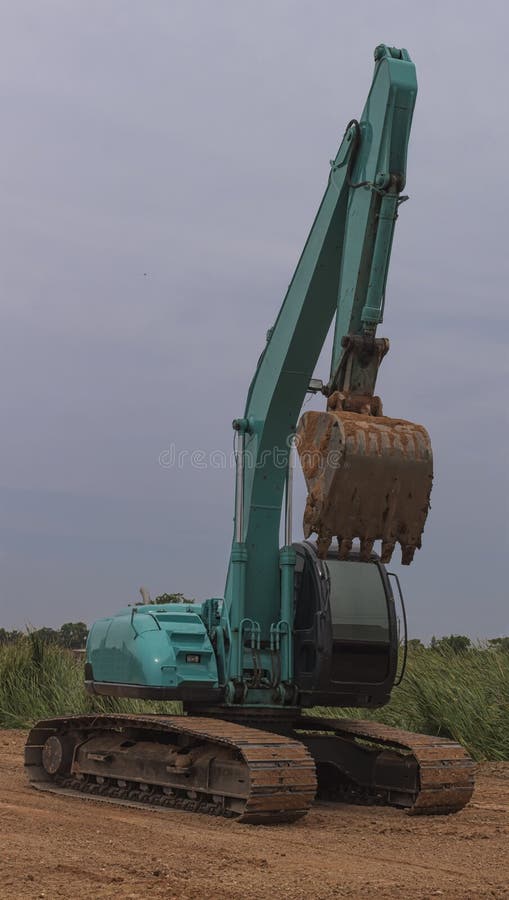 Green Backhoe Dredging Soil Stock Photo Image of hydraulic, bulldozer