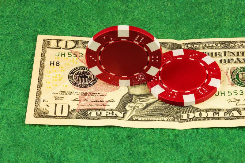 A White Casino Chip Stands on the Reflecting Surface Stock Photo