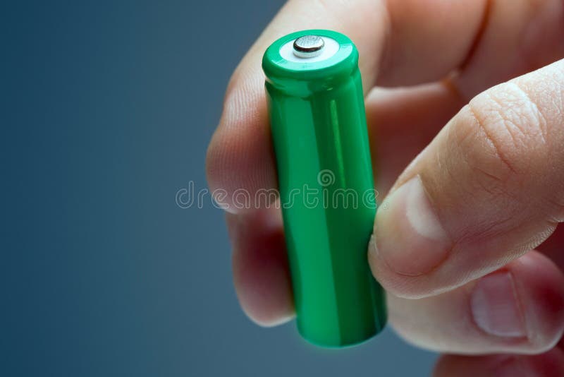 Man Holding a Green Rechargeable Battery Stock Image Image of