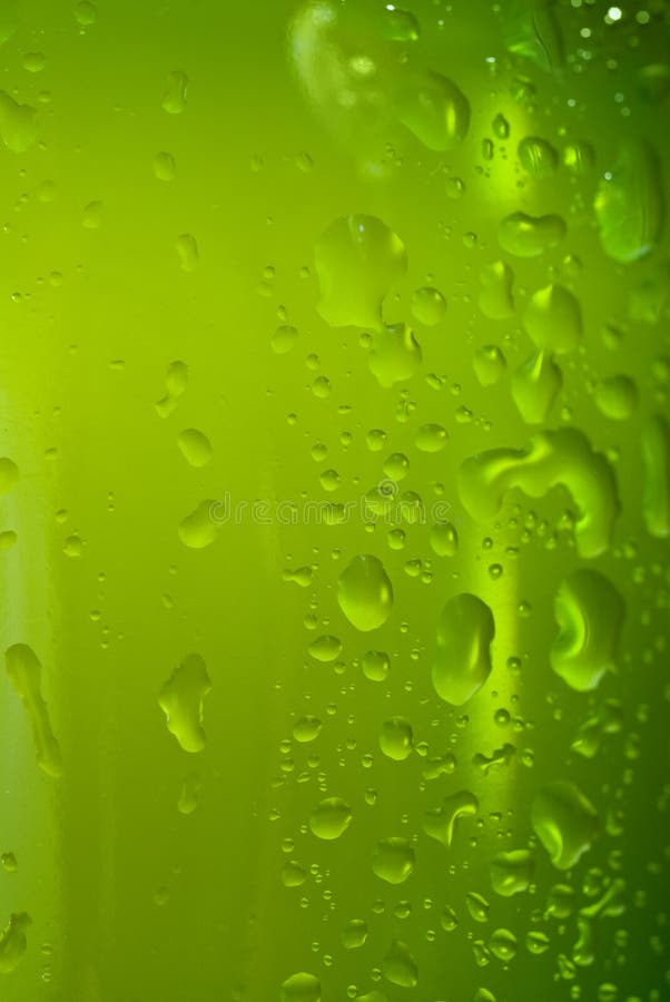 Green beer bottle with water drops