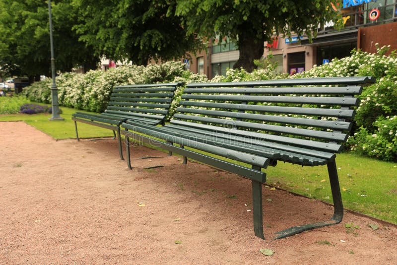 Benches In The Park Next To Water And Old Industrial Facility In The