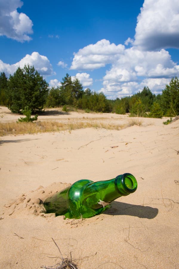 Green bottle on the sand stock image. Image of abstract 22806127