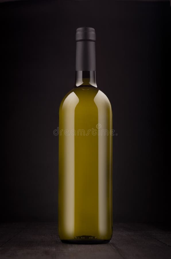 Green bottle of white wine mock up on elegant dark black wooden background, vertical.