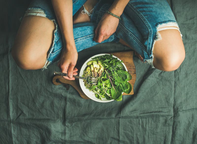 Green breakfast meal with spinach, arugula, avocado, seeds and sprouts