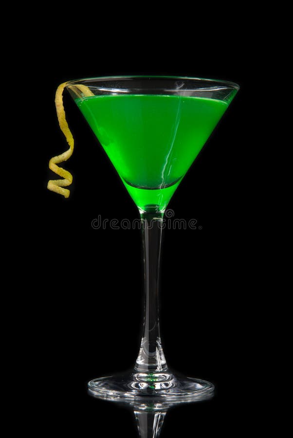 Green cocktail with absinth in martini glass for halloween night