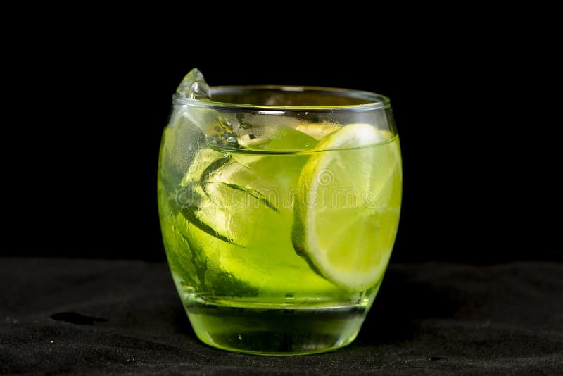 Green Cocktail with Gin, Bitter Lemon, Basil and Lemon Stock Image ...