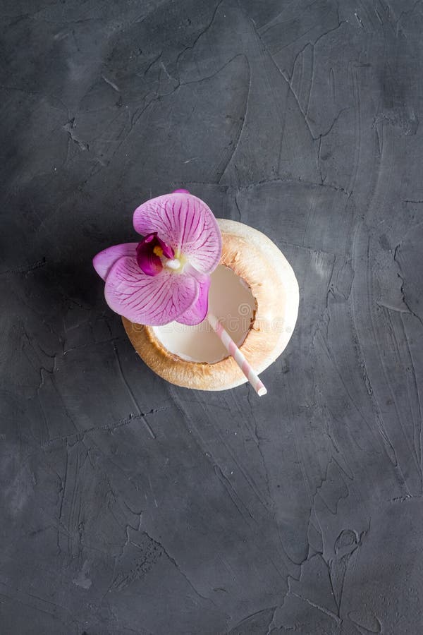 Green coconuts with drinking straw - tropical cocktail, above view