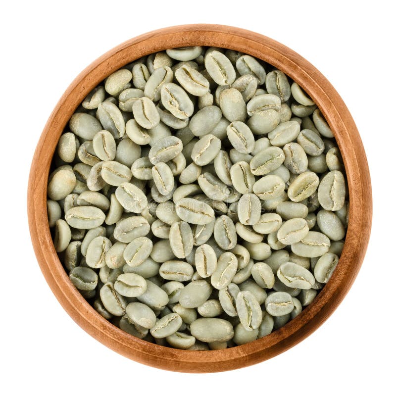 Green coffee beans in a wooden bowl over white