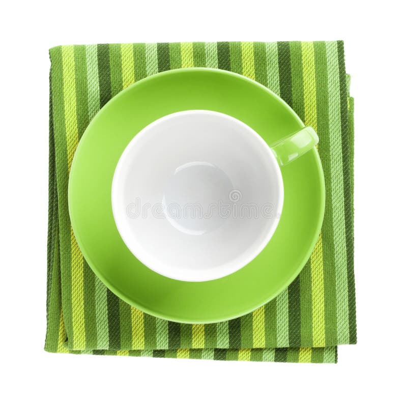 Green coffee cup over kitchen towel