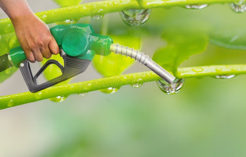 Green conservation. Gas pump nozzle and leaf background. Fuel dispenser on nature background. energy conservation of Nature Concept.